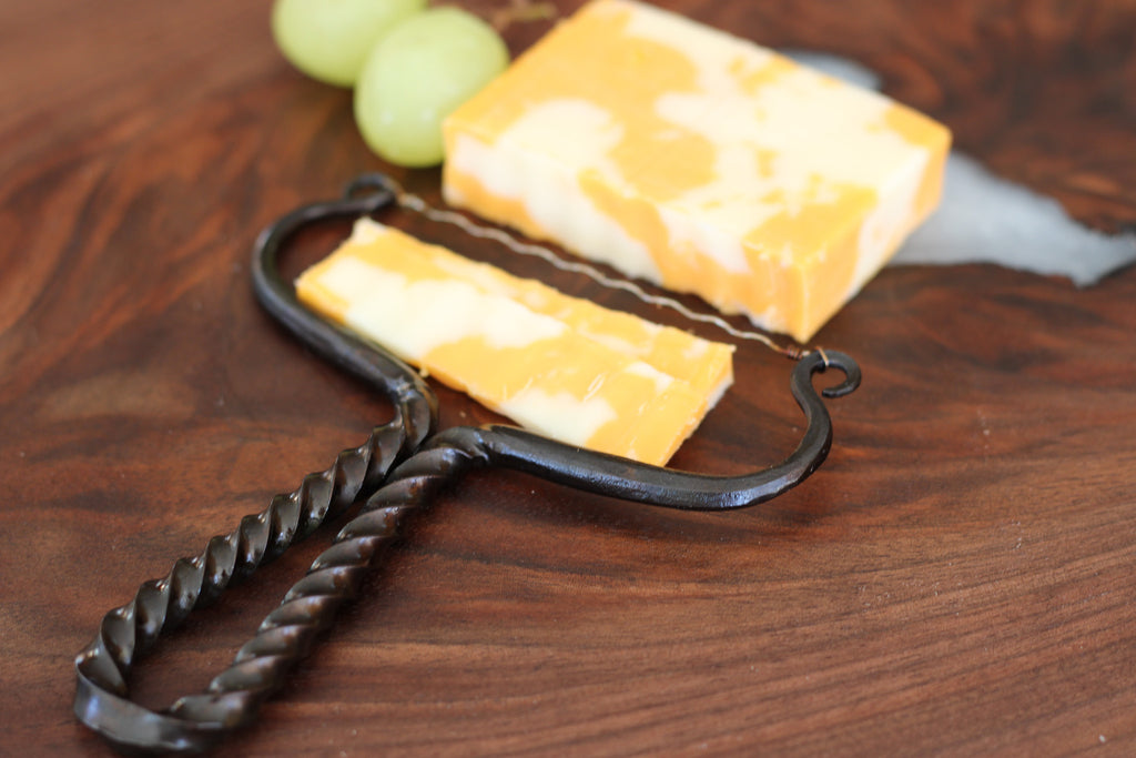 Hand forged and twisted symmetrical cheese slicer with wavy wire