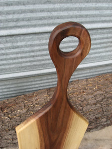 Black walnut charcuterie cheese board with handle.  Close up of handle.