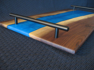 Blue Epoxy River Black Walnut Charcuterie Board/Serving Tray.  Black metal handles pictured.